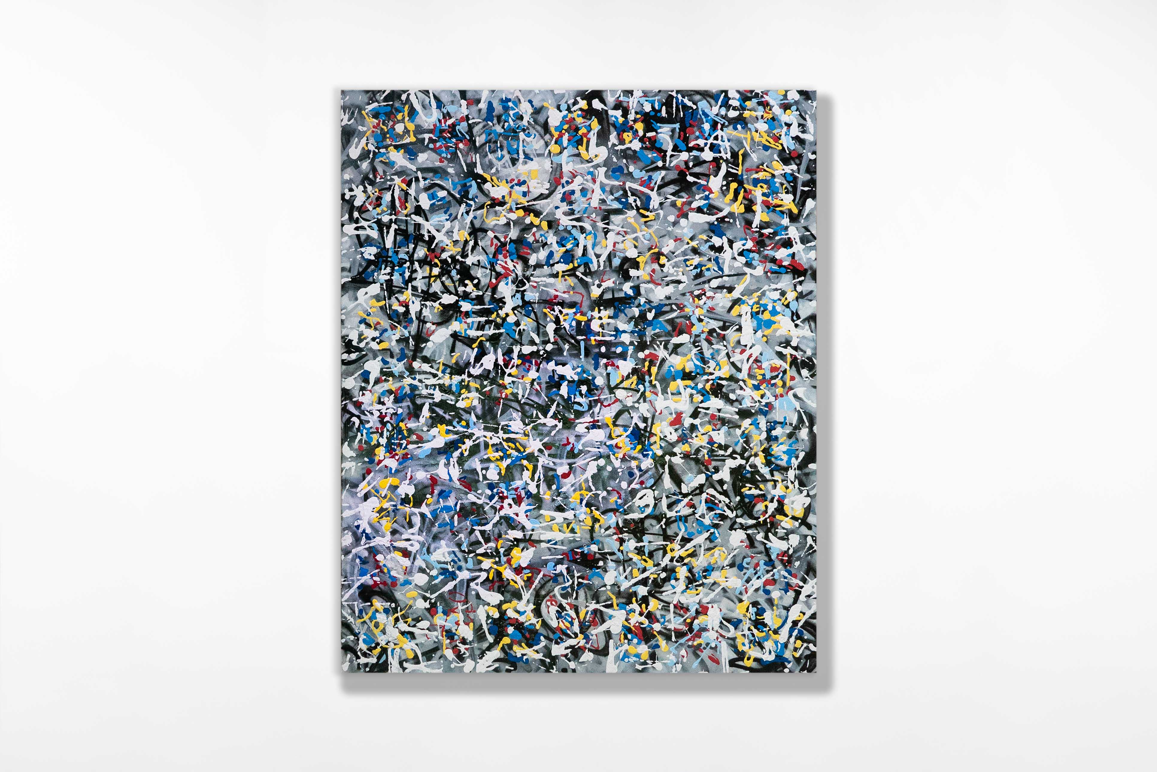 Abstract painting densely layered with gestural white, yellow, blue, and red marks over a smoky grey and black background. The energetic composition is unframed and features overlapping drips, splatters, and linear strokes, creating a vibrant sense of motion and visual noise.