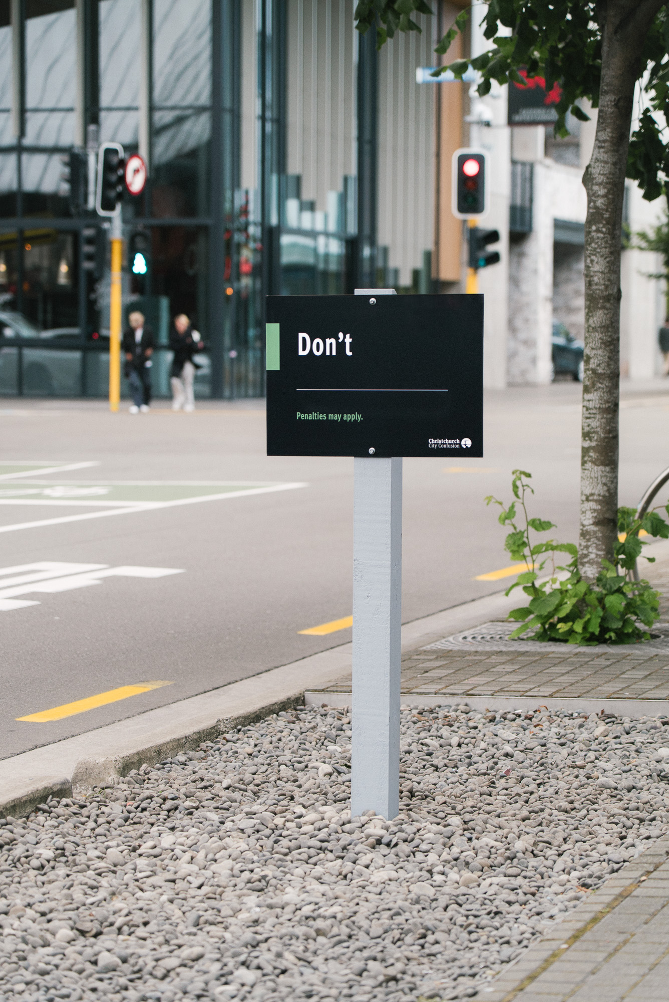 An official-looking Christchurch City Council style sign installed in a public space, displaying a single word — “Don’t” — creating an absurd and humorous moment by street artist Cameron Hunt.