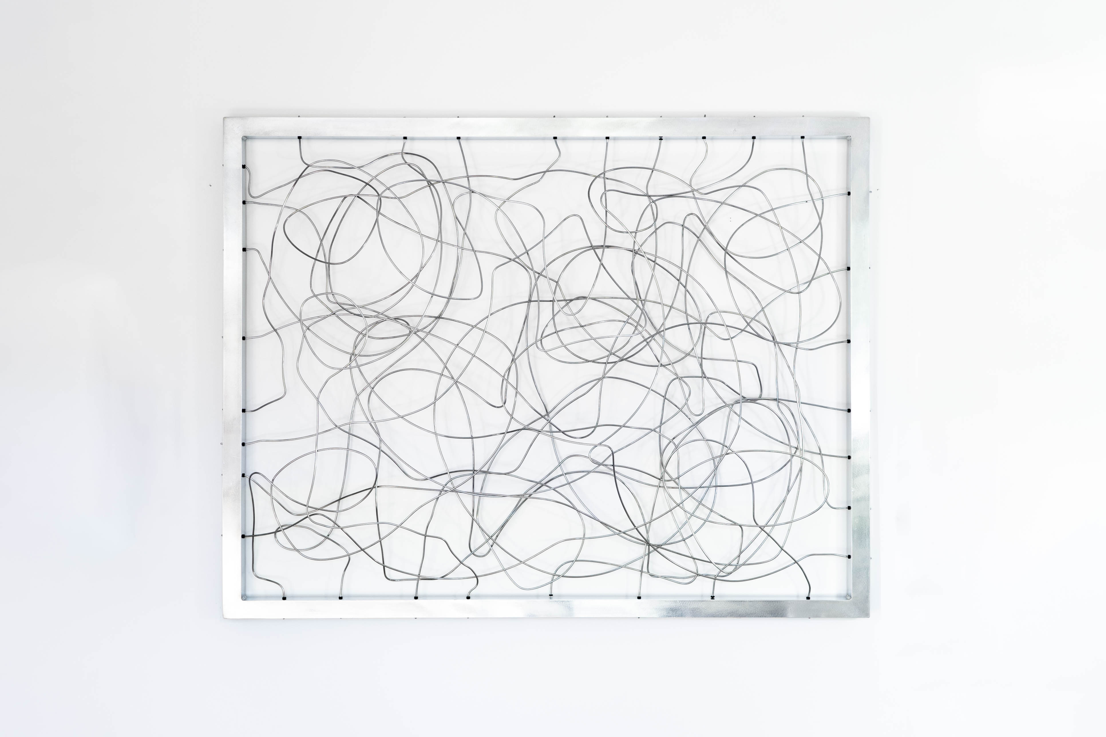 Abstract wire wall sculpture by Cameron Hunt with overlapping metal lines in a modern frame.