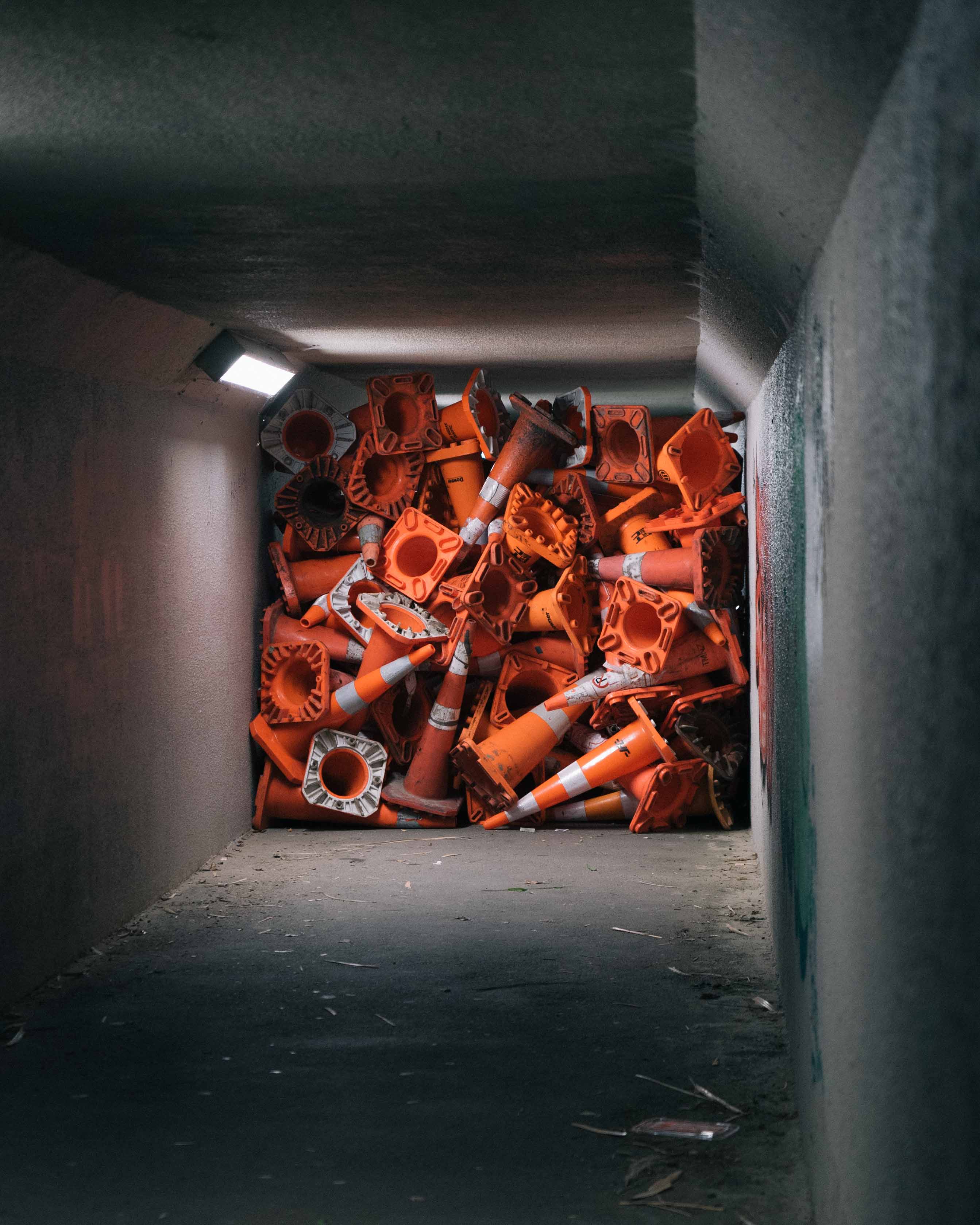 Street art installation by Cameron Hunt featuring a large pile of shopping trolleys accumulated in the corner of a shopping mall carpark.