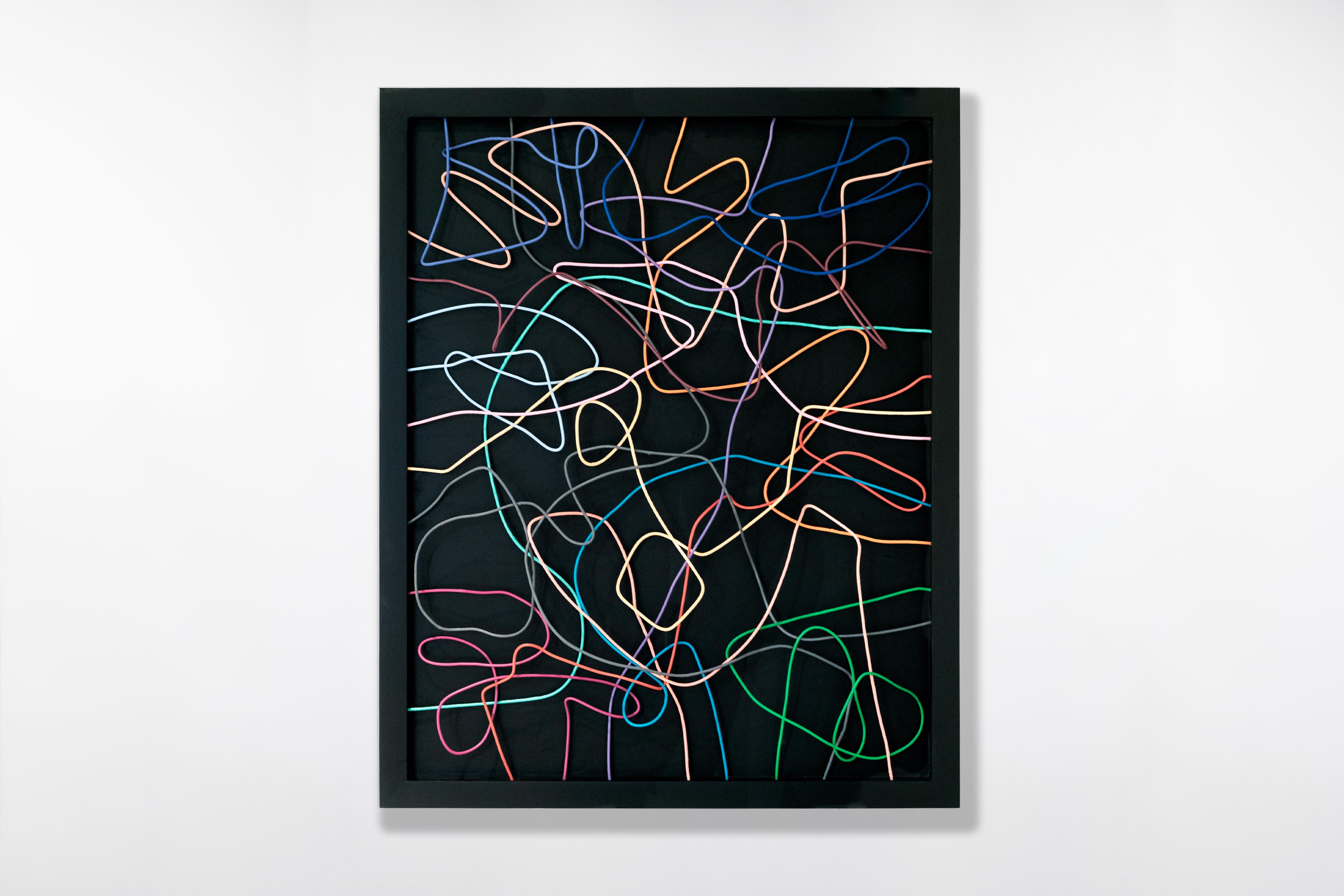 Sculptural wall artwork by Cameron Hunt, featuring colourful interwoven lines looping across a deep black frame.