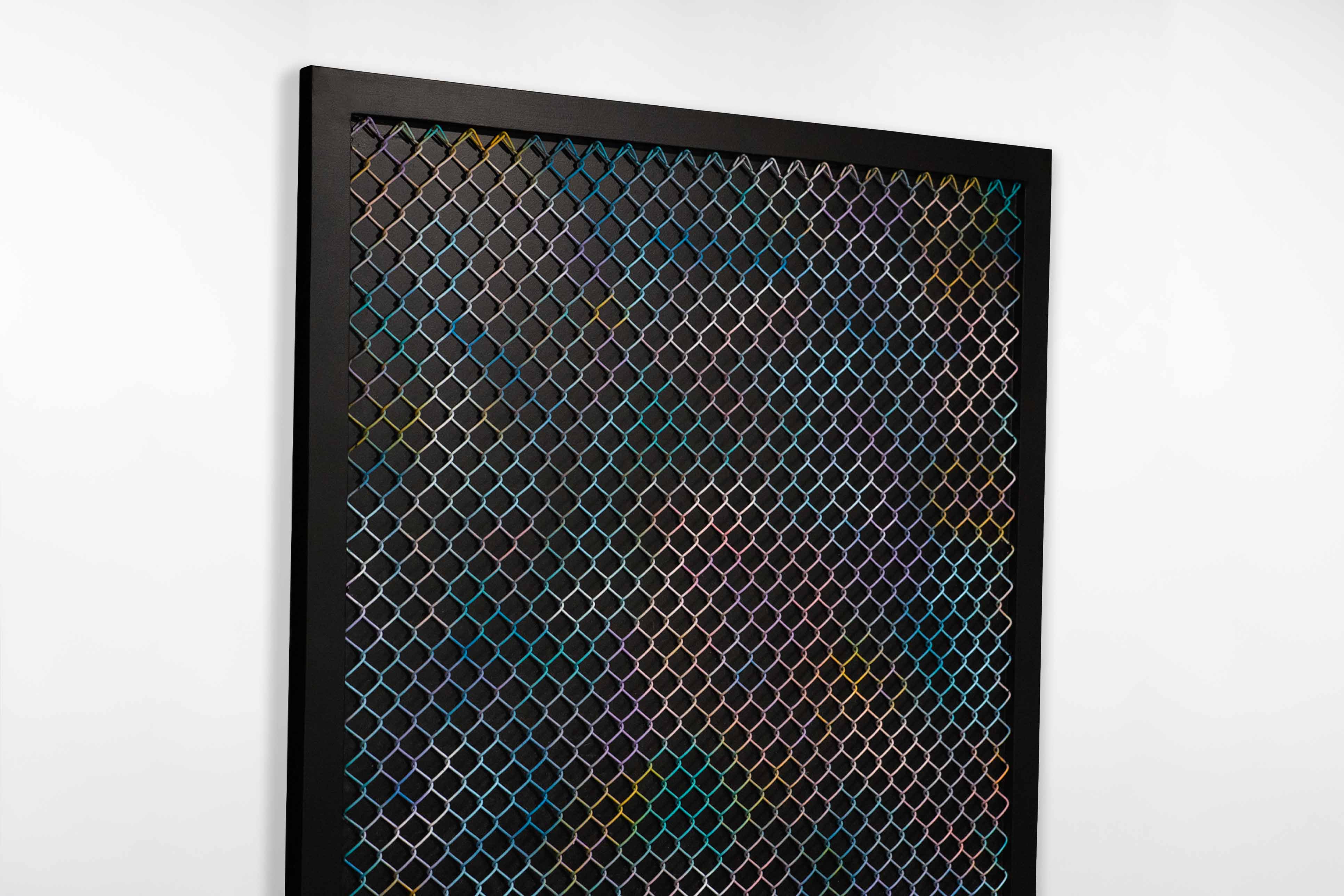 Side angle of a geometric painting by Cameron Hunt with a colourful diamond wire grid mounted over a matte black background.
