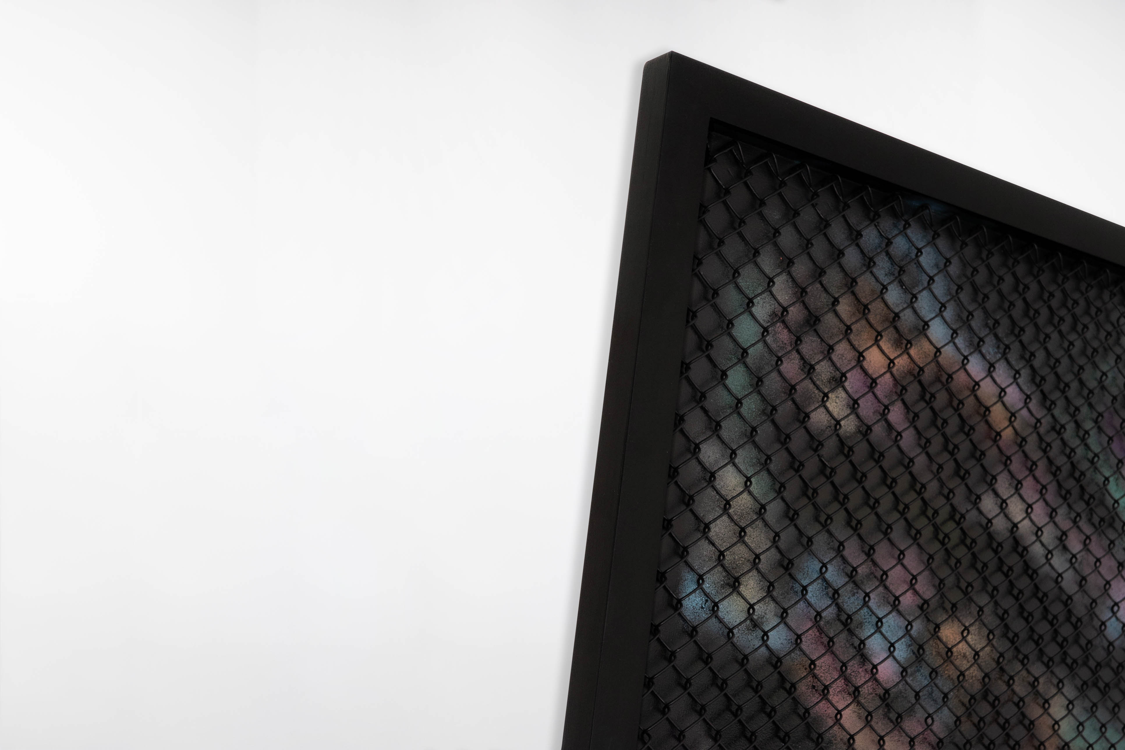 Close-up corner view of a painting by Cameron Hunt, highlighting the layered depth between the black diamond-patterned mesh and the muted, colourful background beneath. The surface texture and frame detail are clearly visible.