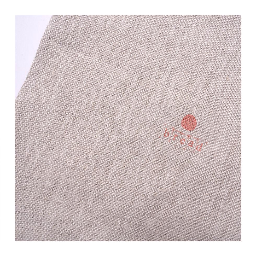 Thumbnail: Linen artisan bread bag open. Lined with feature red drawstring.  close up of stamped bread motif.