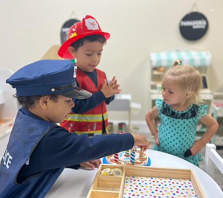Children playing dress-up in bilingual preschool classroom