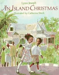 Children hold hands, walking happily outside a Caribbean-style house with palm trees. The cover reads "An Island Christmas" by Lynn Joseph.
