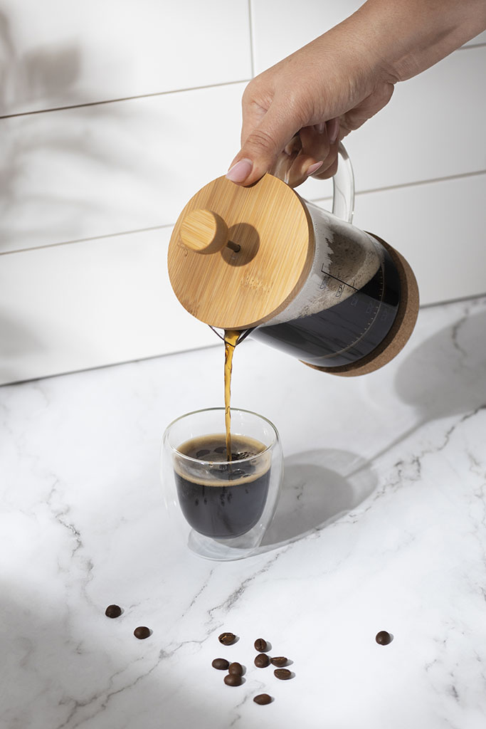 A cup of coffee and tea served with pure water in a cozy setting