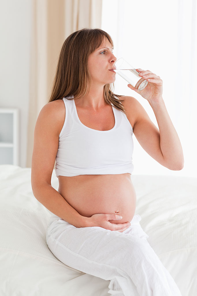 Pregnant mother testing water quality in Sarasota home