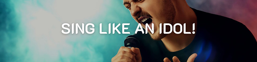 Image of a man holding a microphone for singing lessons in Antelope