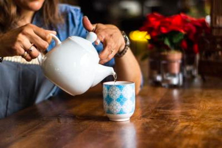 Woman pouring a cup of tea