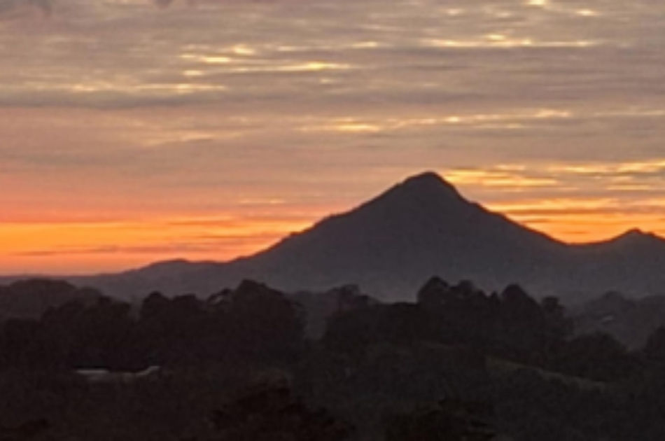 Sunset over a mountain landscape, symbolising house and land energy healing sessions that restore harmony and balance to spaces.