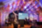 Speakers at the D5 Ministerial Summit in a vaulted room, held in New Zealand