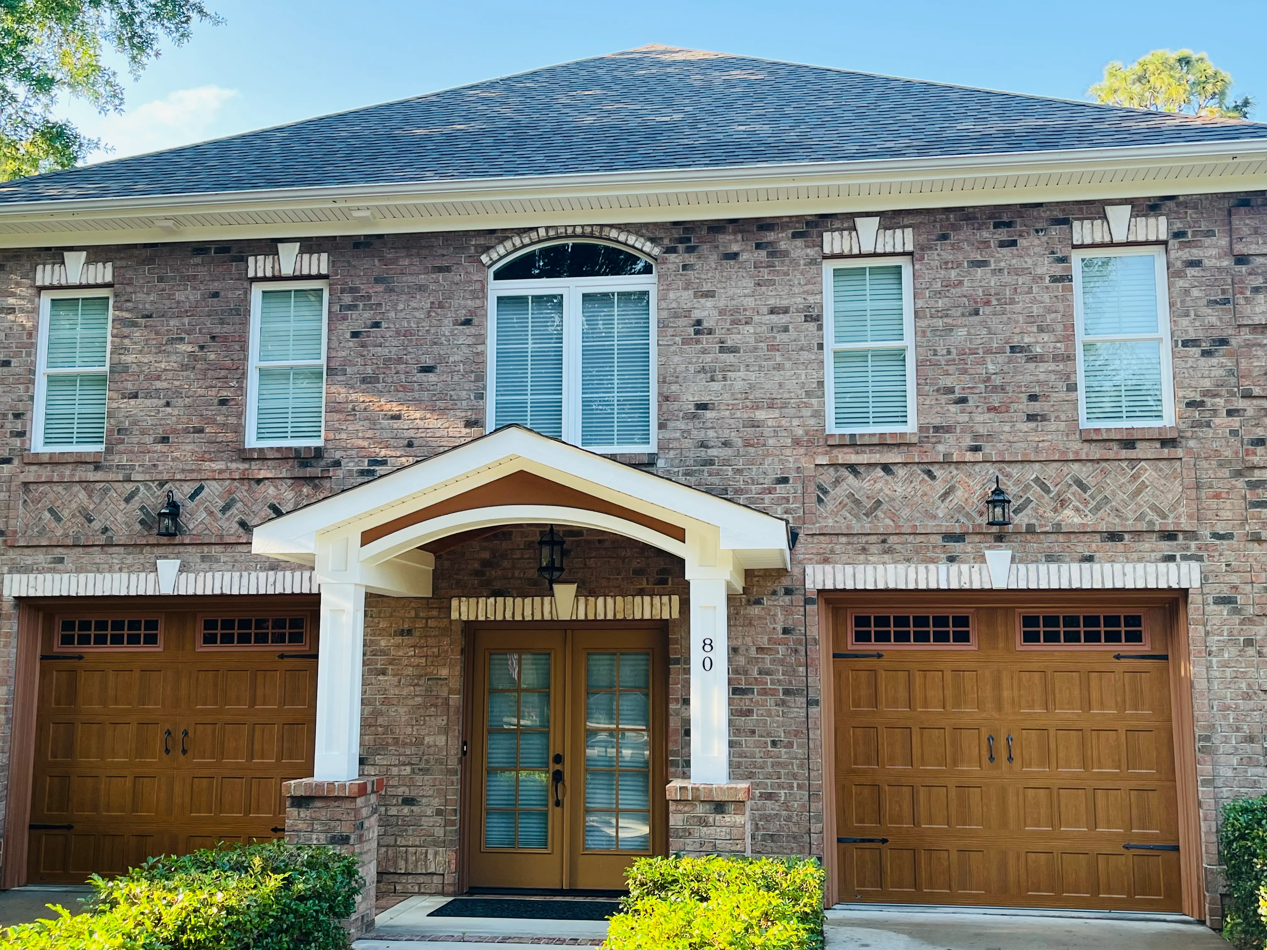 Front of red brick Pinehurst home with pressure-washed facade.