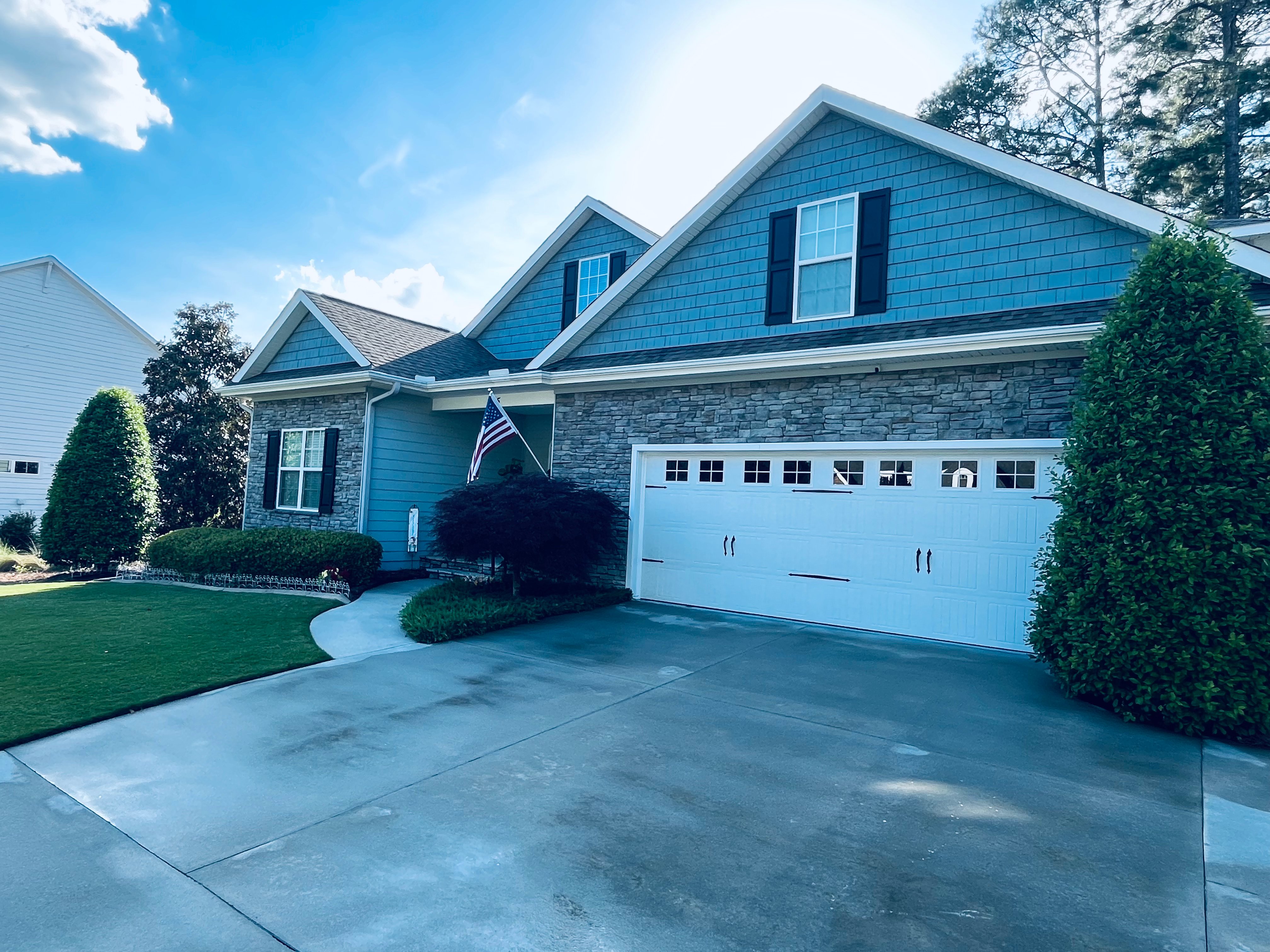 Bright driveway and clean garage front after pressure wash in Aberdeen NC
