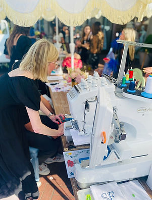 Emily, owner, at Alice & Olivia in Highland Park Village during on-site embroidery
