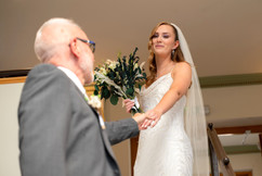 Father of the bride holds out his hand to welcome his daughter as she arrives at her wedding at the Sun Pavilion Harrogate  