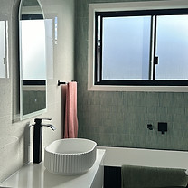 “Clean and accessible bathroom with shining tiles and fixtures, maintained as part of NDIS and DVA home cleaning support by K