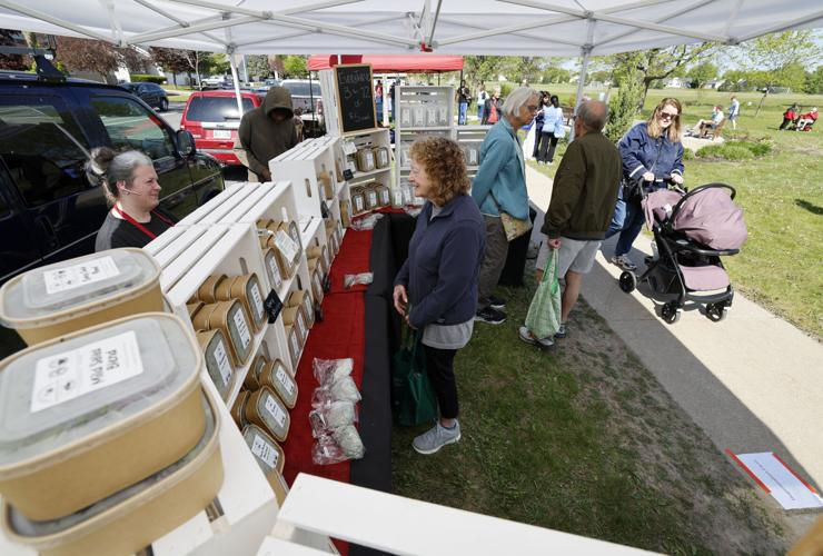 People perusing items at a farmers market