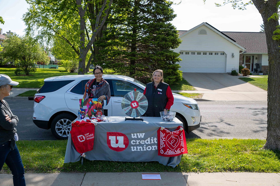 UW Credit Union table with swag and two women standing behind it