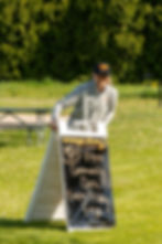Woman placing sign for community workout session