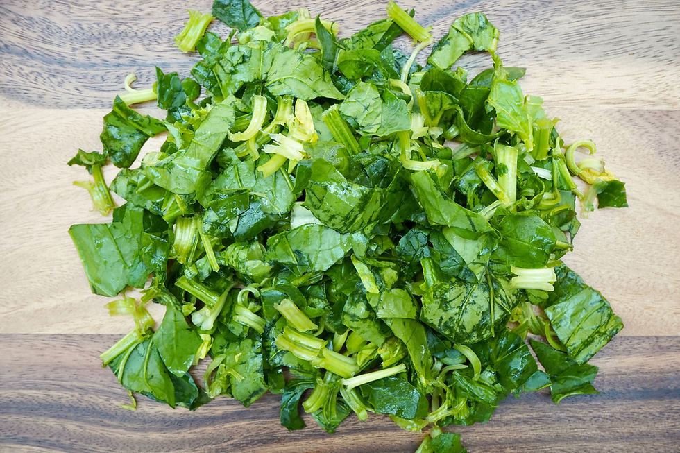 Cut spinach on a chopping board to prepare yumurtalı ıspanak