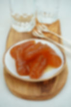 Turunç macunu (bitter orange spoon sweet) served on a small plate with water on the side