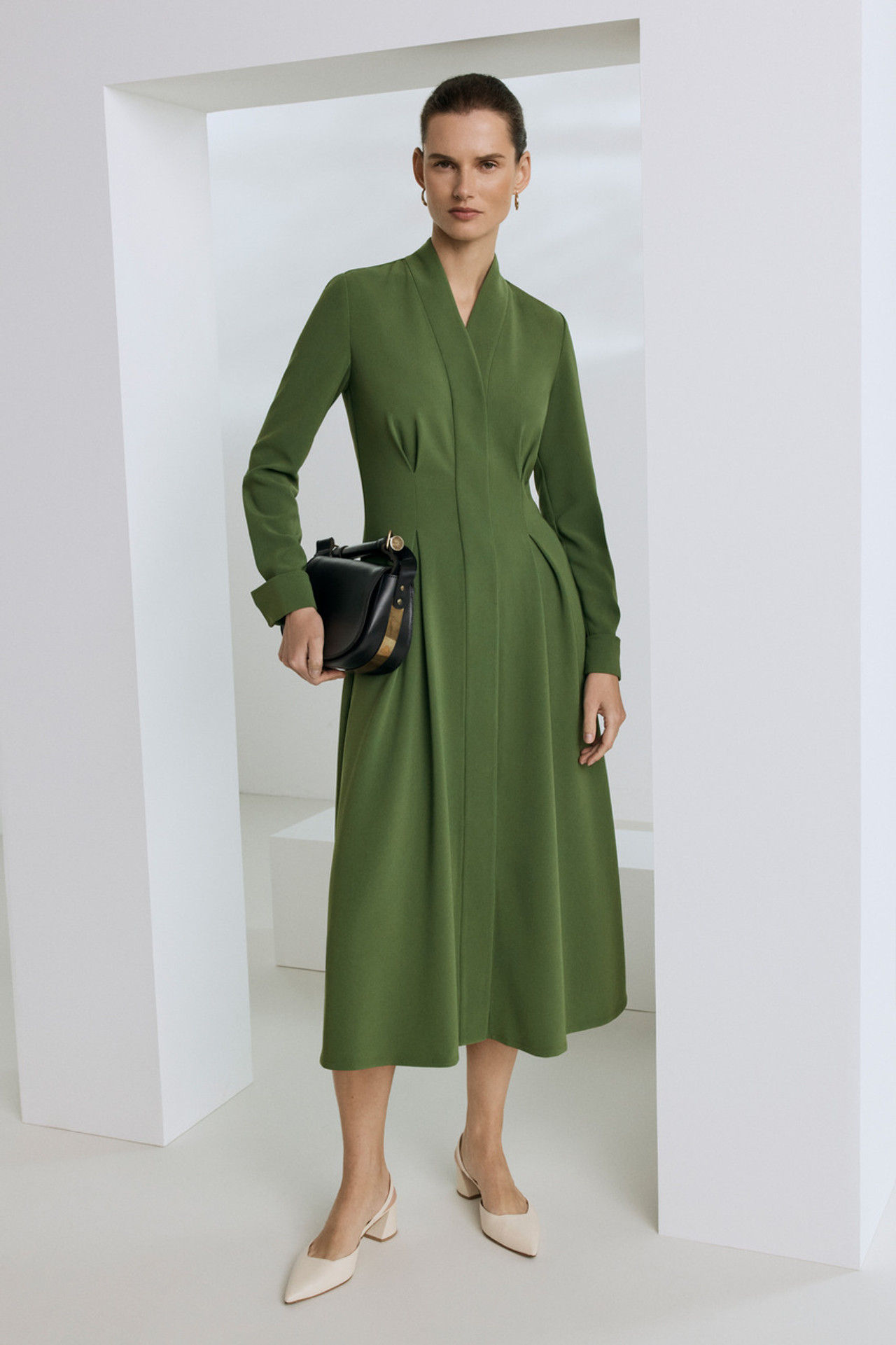 Woman in olive green midi dress