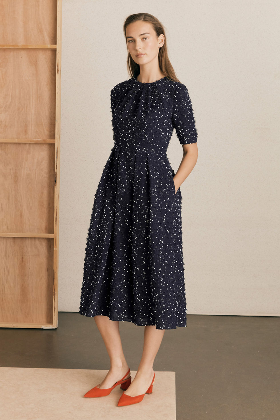 Woman in navy textured midi dress