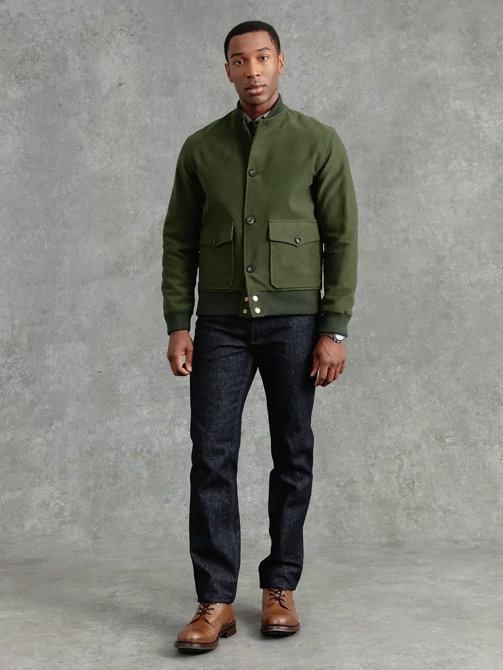 Man in olive bomber jacket and dark pants