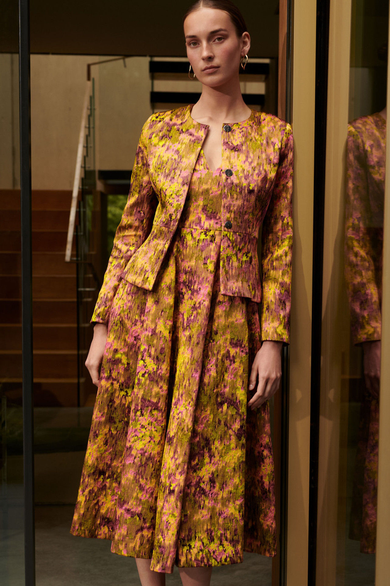 Woman in floral brocade dress and jacket