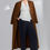 Thumbnail: Woman in brown coat and white top