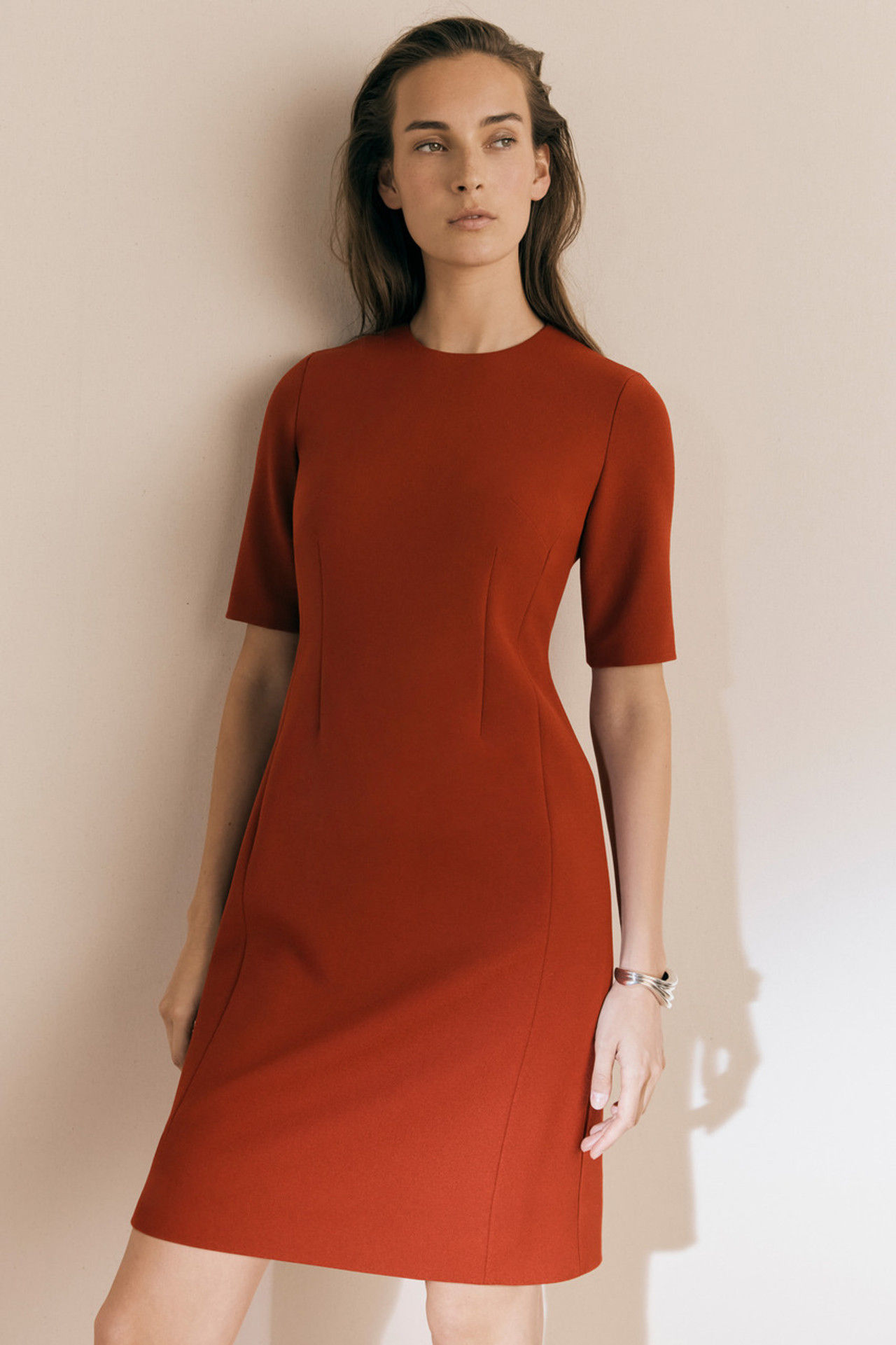 Woman in burnt orange short-sleeved dress