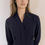 Thumbnail: Woman in a navy collared shirt