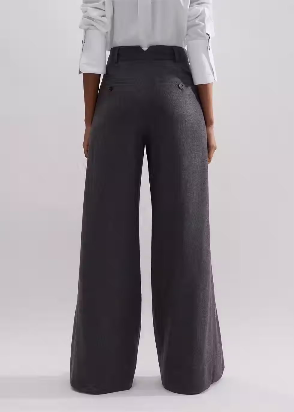 Woman wearing dark wide-leg trousers