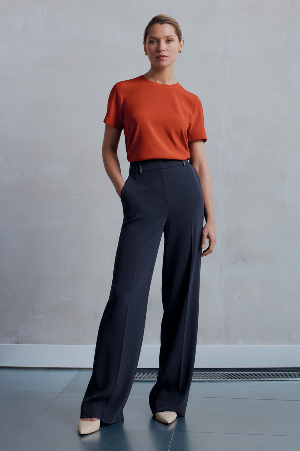 Woman in rust top and dark pants