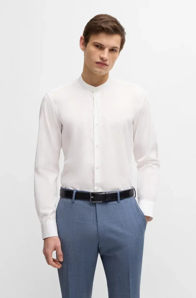 Man in white collared shirt and blue pants