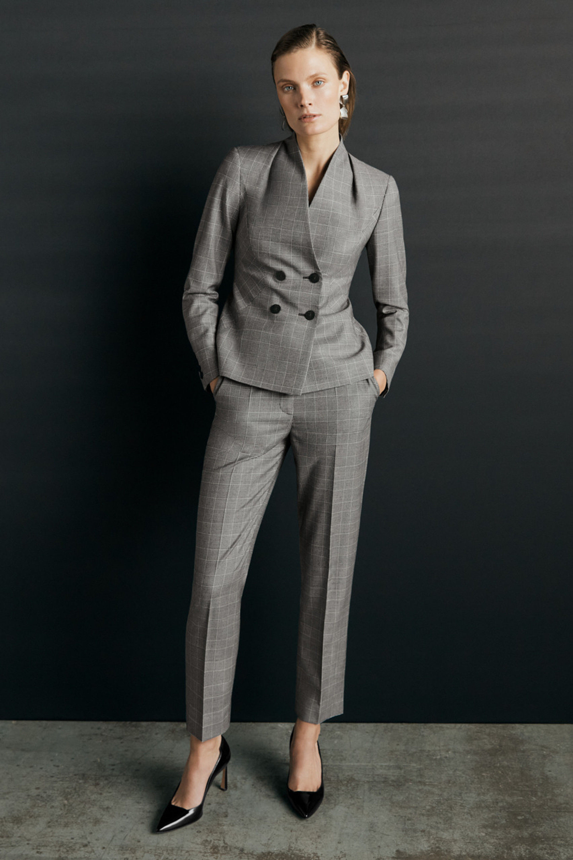 Woman in gray pinstripe pantsuit
