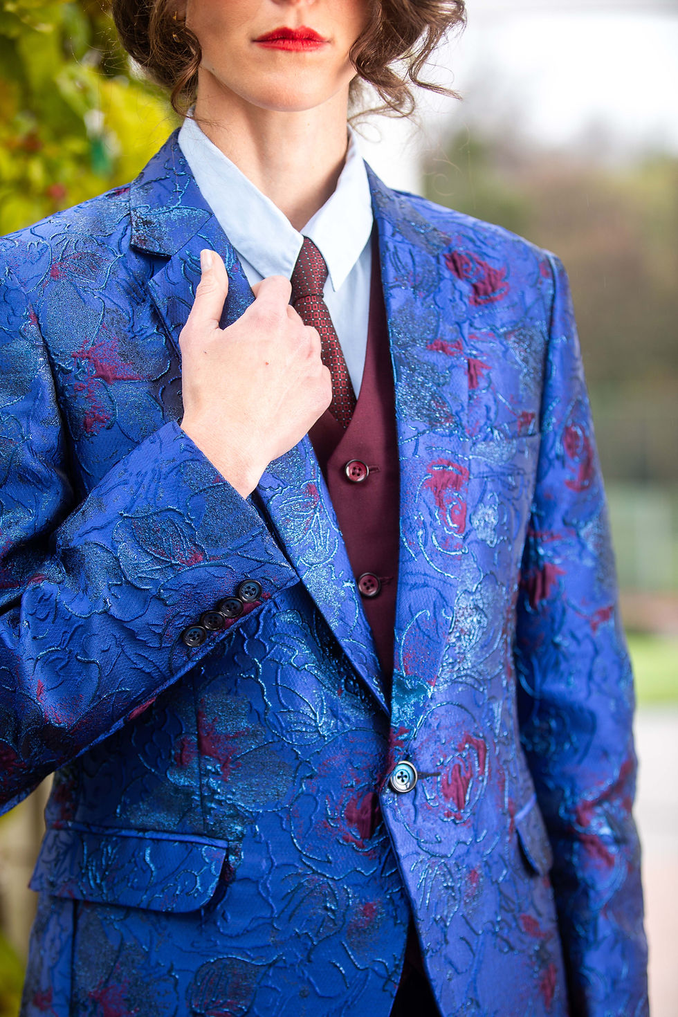 Man adjusting blue patterned suit jacket