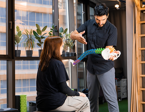  Doctor pointing at spinal model.