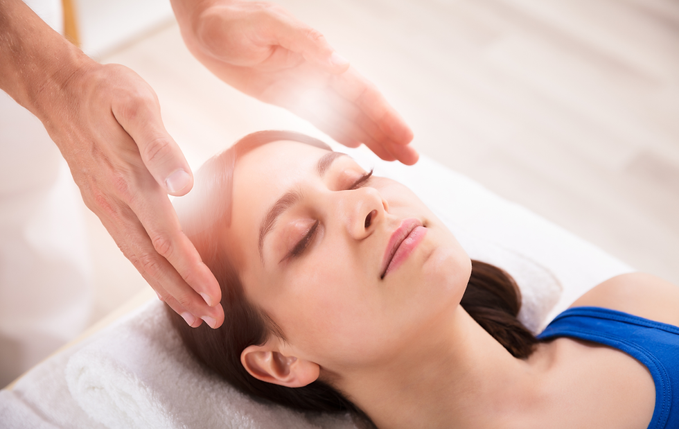Reiki practitioner healing a woman's head.