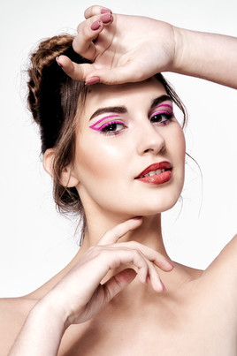 High-key beauty portrait of woman with pink graphic eyeliner makeup and styled hair, photographed by Joana Santos in her Odeceixe studio. Model Lara is captured in a timeless and sophisticated look, with makeup by Joana Martins and hair styling by Yana Skoroda. Copyright © 2023 Joana Santos, Commercial Photographer