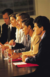 Professionals sitting at a conference table in a meeting