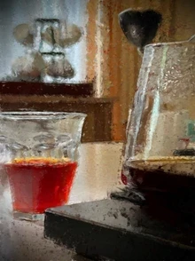 Carafe of coffee and a glass of red drink