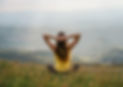 Woman sitting on a hill, symbolizing a client struggling with depression, trauma, low self-esteem, or addiction — contact psychotherapist Anne Kamau for help.