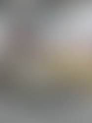 University sports lounge overlooking the football stadium, furnished with Ace 2.0 modular seating in gray, Sky tables with plinth bases, and bright yellow Gio swivel chairs, set against a football mural feature wall.