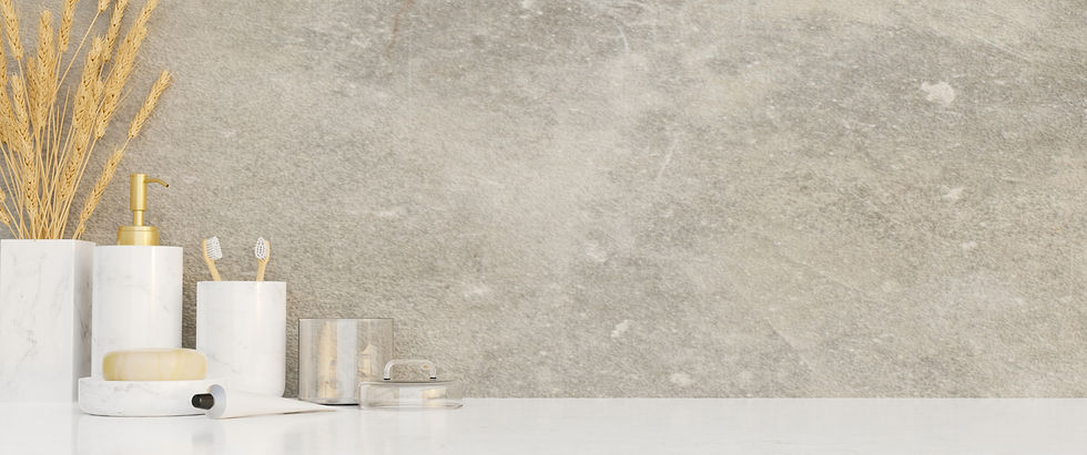 Minimalist bathroom countertop with white and gold accessories.