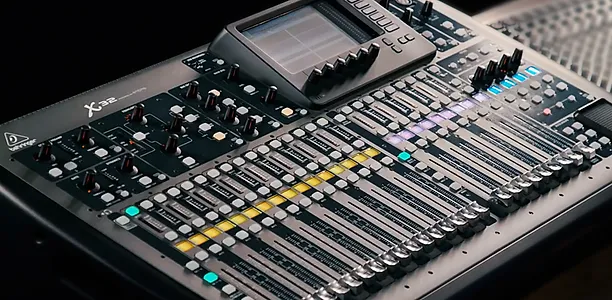 a close-up of a digital mixing board