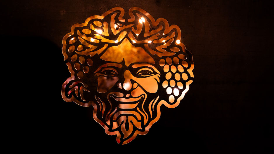 Photo of Bacchus carved the safety rails of the balcony at the wine bar ArtVin3.