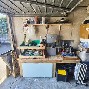 a electrical workbench that has been taken over by woodworking tools in landscape