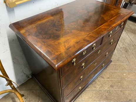 We had to completely veneer the top of this 17th century walnut chest with bookmatched veneers, herringbone bandings and a cross banded edge.